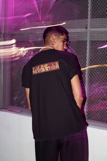 Person wearing a black t-shirt with text on the back in a futuristic setting.