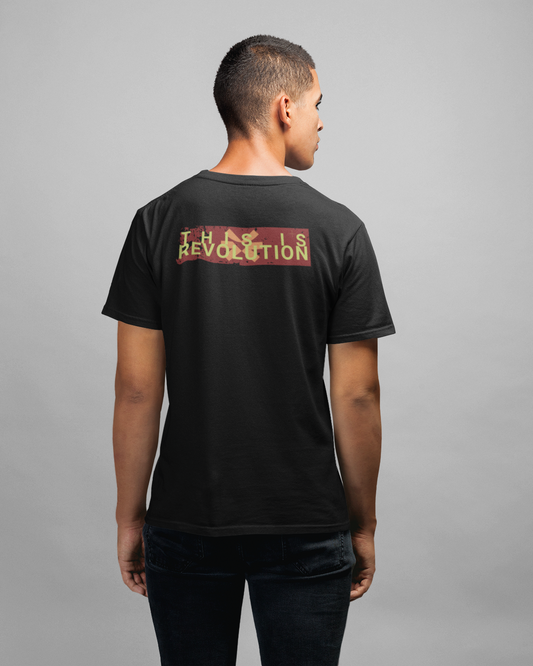 Person wearing a black t-shirt with text on the back against a gray background