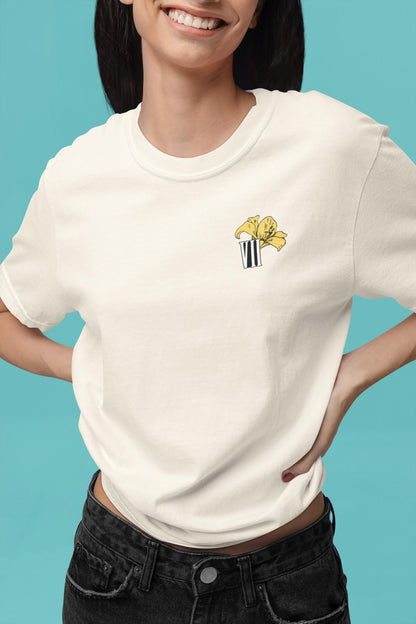 Model wearing Aerith flower minimal Final Fantasy VII pastel t-shirt with yellow lily design