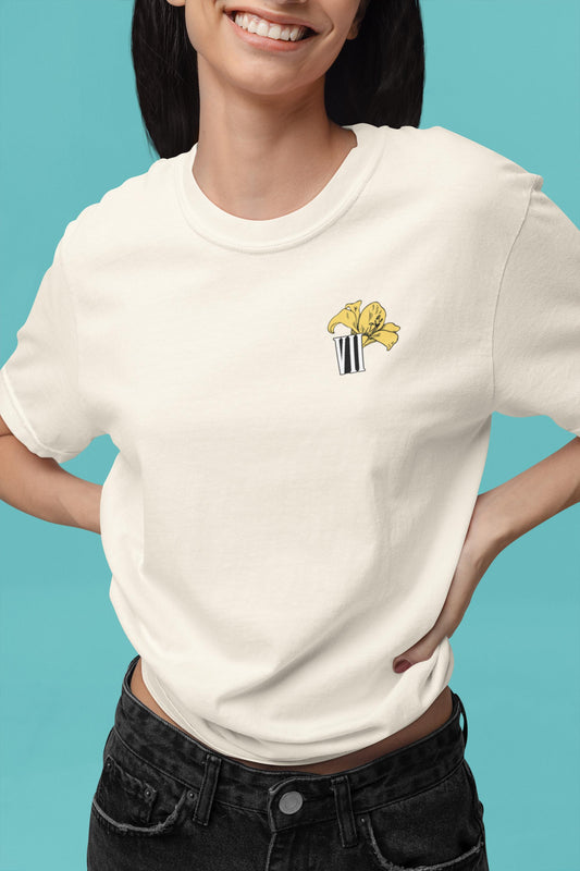 Model wearing Aerith flower minimal Final Fantasy VII pastel t-shirt with yellow lily design